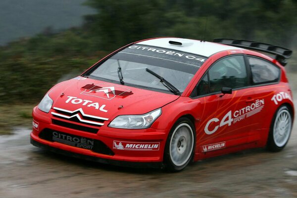 Red citroen c4 on a wet road