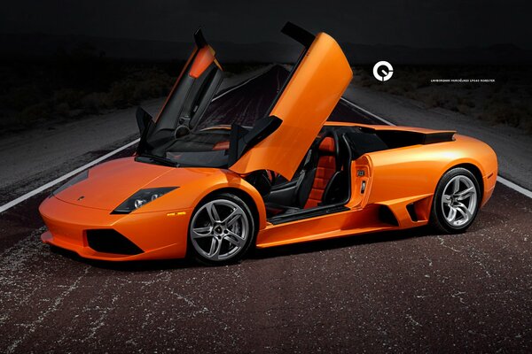 Orange Lamborghini Murcielago stands in the middle of an asphalt road