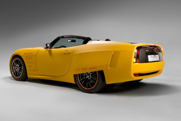 Yellow electric supercar on a gray background