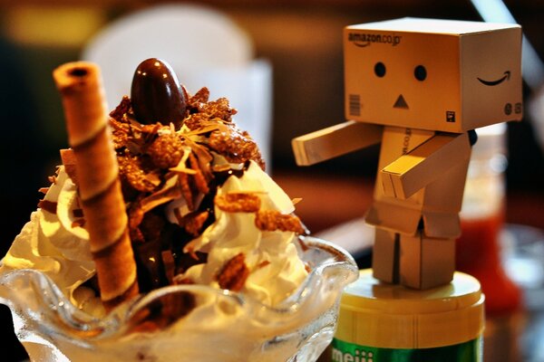 Sweet dessert with chocolate and cream, with a toy on the background