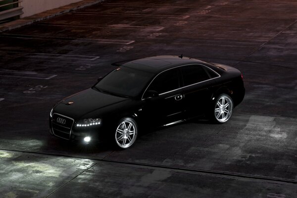 Black Audi in the night parking lot