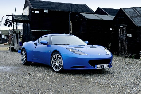 Blue car on the background of a black building