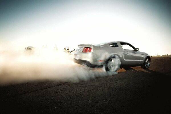 Drift on asphalt. Grey sports car