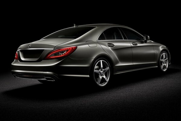 Black Mercedes on a black background rear view