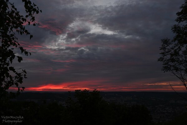 Crimson sunset over the falling asleep city