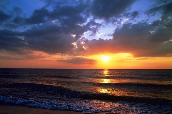 Sea and beach on sunset background