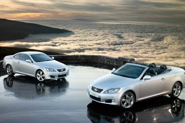 Lexus cars in a mountainous area against the background of clouds