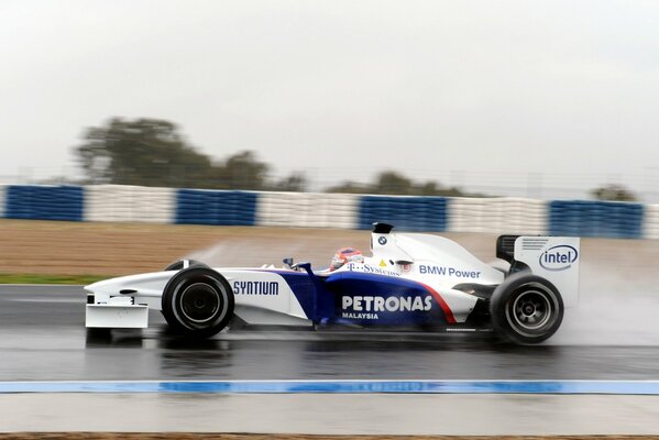 A racing car is racing along the track