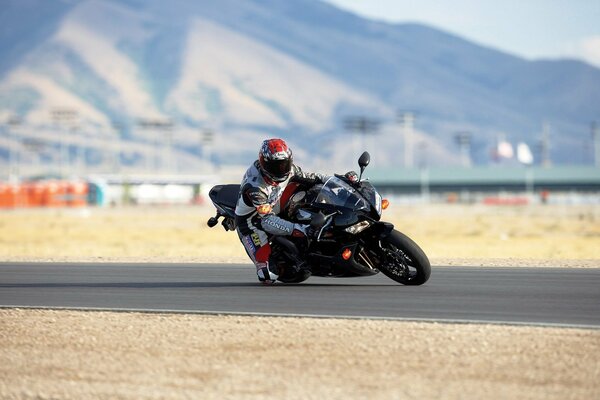 On a racing track, a motorcyclist riding a sports bike