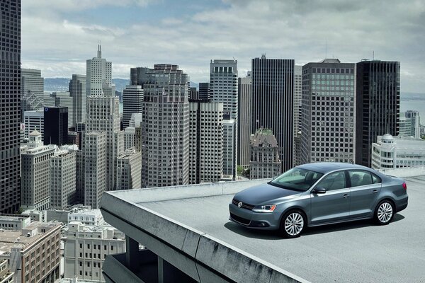 Volkswagen car in the city on the roof of the house