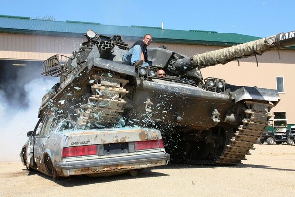 A tank crushes a passenger car