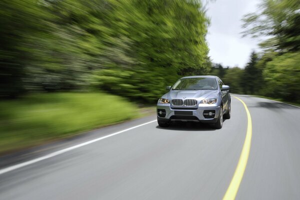 Blurred background of a country road with a bmw