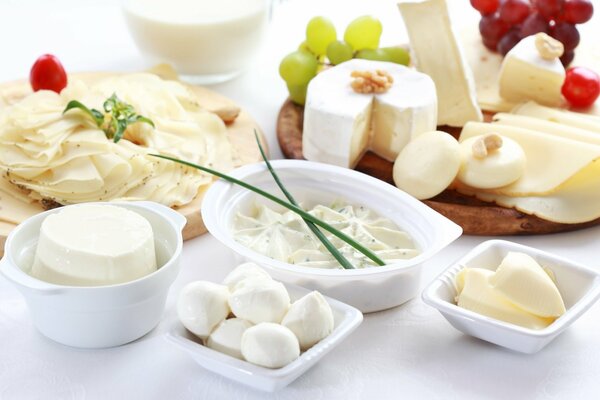 Dairy products with grapes and nuts on the table