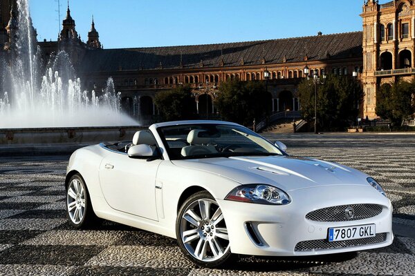 White car at the fountain on the square