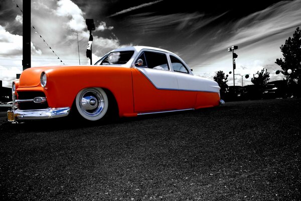 Retro-style car in orange and white coloring