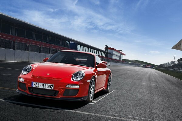 Red Porsche 911 on the asphalt at the start line