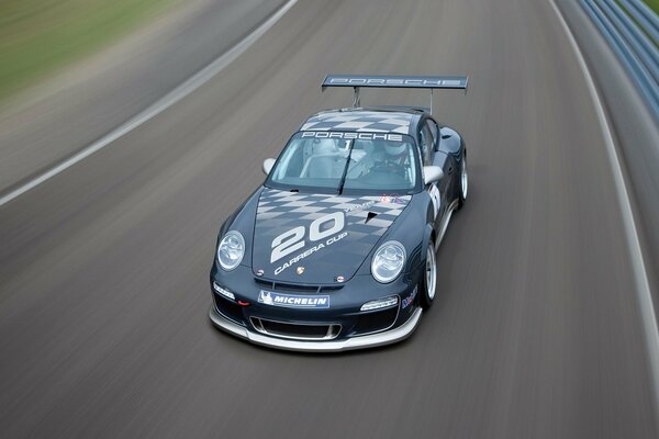 A sporty Porsche is racing along the highway