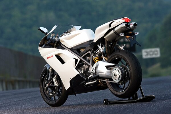White ducati motorcycle on a mountain road