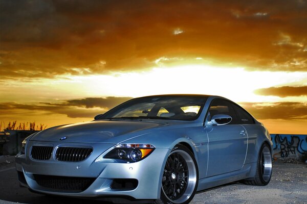 Grey BMW on a beautiful sky background