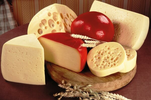 Delicious cheese on a wooden tray