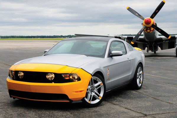 Ford Mustang on the background of an airplane