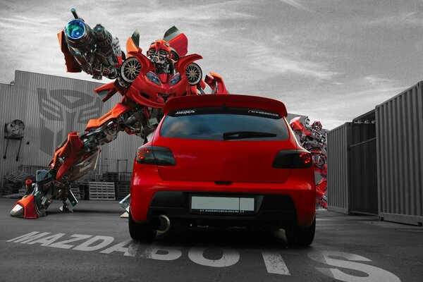 Red mazda car among the transformer