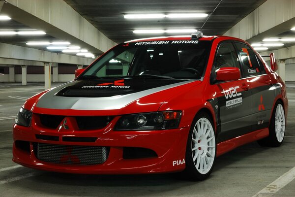 Red mitsubishi in an empty parking lot