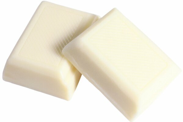 Pieces of white chocolate on a white background