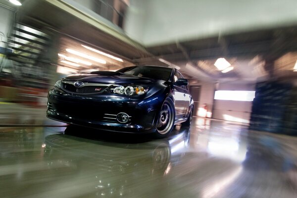 Black Subaru on the glossy floor in the garage