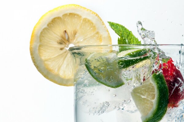 Juicy lemon and lime in a glass of water