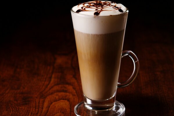 Latte coffee with foam on the table