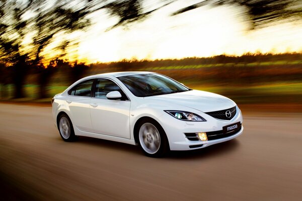 Elegant white mazda on the highway