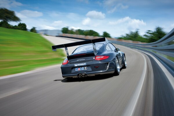 A high-speed Porsche is flying on the highway