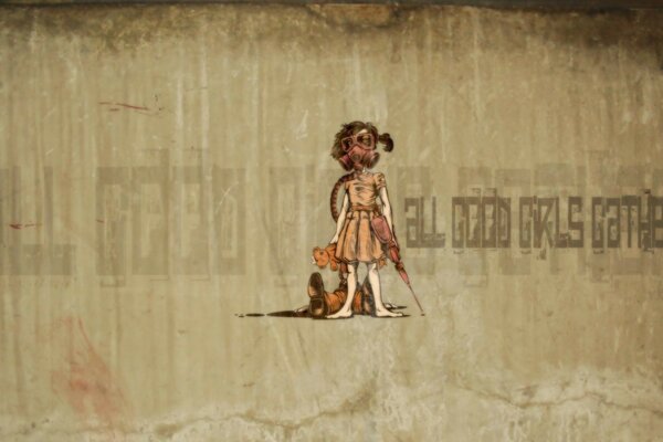 Graffiti on the wall. A girl with a bear