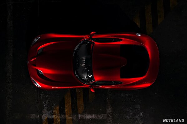Top view of a red car in the dark