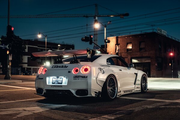 Car at night on the background of city houses