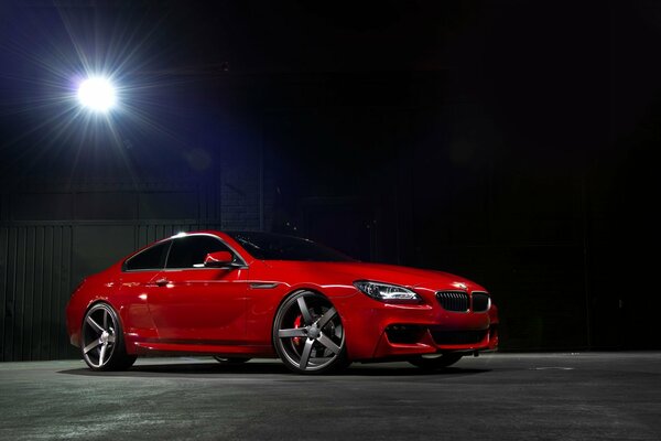 Red bmw 6 Series on the moonlight playground