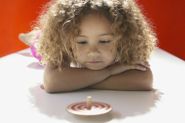 Curly-haired girl looks at yula