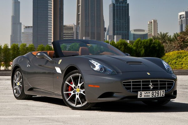 Ferrari California on the background of skyscrapers