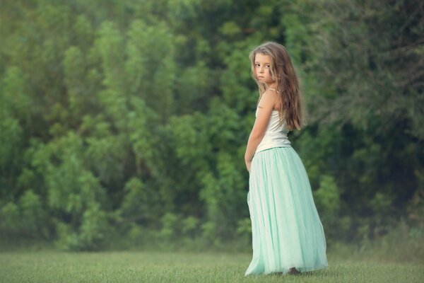 Ragazza con i capelli lunghi sullo sfondo della foresta