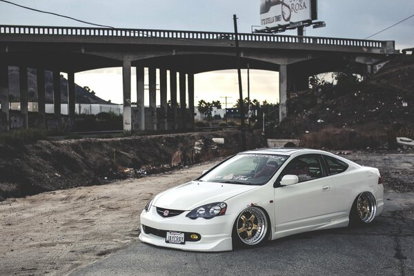 White sports car on the background of the bridge