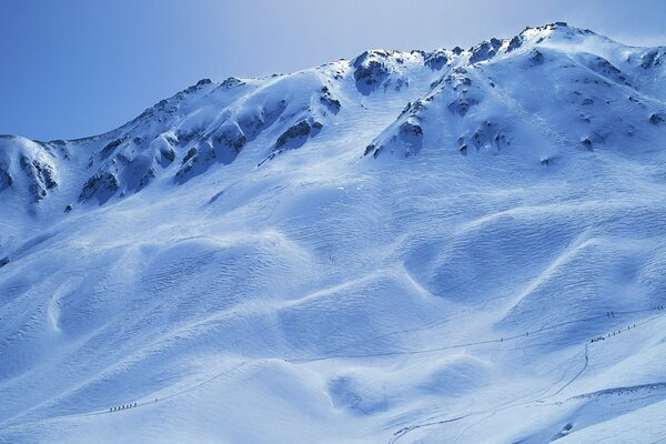 Snowy mountains under a blue sky