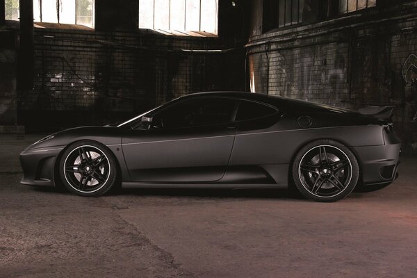 A black Ferrari in a dark room