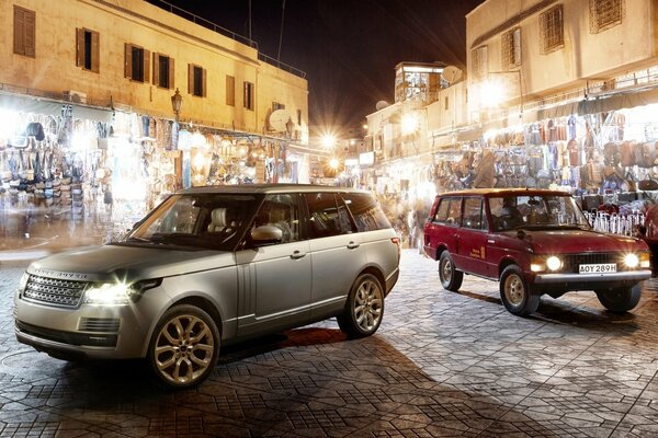 Land rover cars in the middle of the city at night