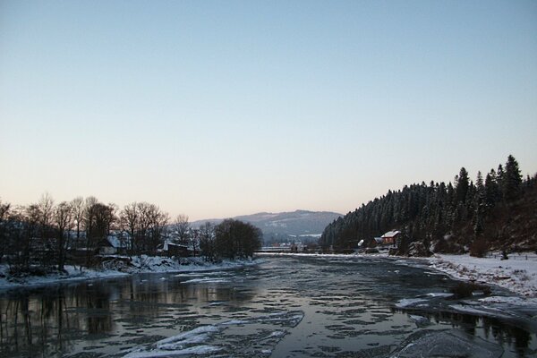 Winter river on the background of the forest