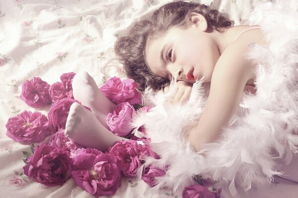 A dreaming girl in roses. A thoughtful ballerina. Roses and a girl. Beautiful frame