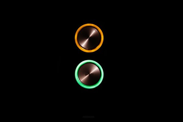 Orange and green buttons on a black background