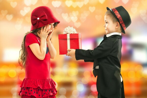 A boy gives a girl a gift