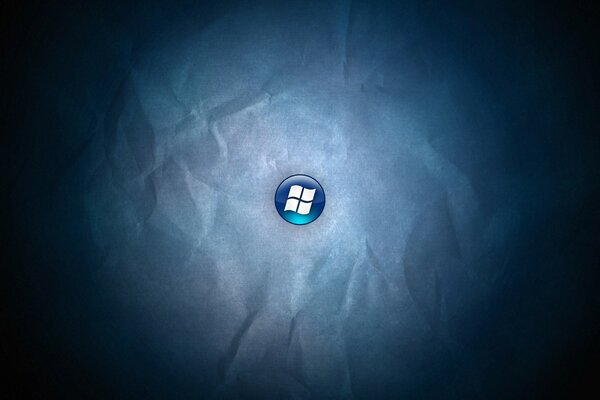 Windows logo on a blue button on a background of crumpled paper
