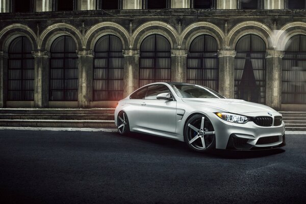 BMW coupe m4 near the city building